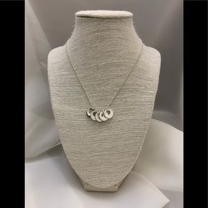 Silver necklace with multi layered rings.